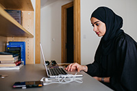 NYUAD student working on her laptop